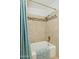 Bathroom featuring a bathtub and shower with tiled walls and a decorative accent strip at 7042 N 13Th St, Phoenix, AZ 85020