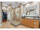 Neutral bathroom with glass-enclosed shower, granite vanity, and walk-in closet at 7042 N 13Th St, Phoenix, AZ 85020