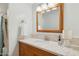 Well-lit bathroom featuring a spacious vanity with modern fixtures and a decorative mirror at 7042 N 13Th St, Phoenix, AZ 85020