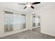 Cozy bedroom featuring mirrored closet, ceiling fan, and bright natural light at 7042 N 13Th St, Phoenix, AZ 85020