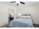 Bedroom featuring bright natural light, ceiling fan, and mirrored closet at 7042 N 13Th St, Phoenix, AZ 85020