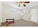 Bright bedroom with neutral carpet, ceiling fan and double doors to the exterior at 7042 N 13Th St, Phoenix, AZ 85020