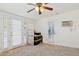 Bright bedroom with neutral carpet, ceiling fan and double doors to the exterior at 7042 N 13Th St, Phoenix, AZ 85020