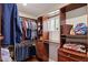 Spacious walk-in closet offers ample storage and organization, featuring wooden shelving at 7042 N 13Th St, Phoenix, AZ 85020