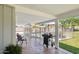 Relaxing covered patio with comfortable seating, a grill, and views of the backyard pool at 7042 N 13Th St, Phoenix, AZ 85020