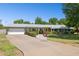 A single-story home with an extended driveway, attached garage, and a neatly landscaped front yard at 7042 N 13Th St, Phoenix, AZ 85020