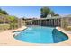 Inviting pool area with a lounge area, mature trees, and privacy fencing at 7042 N 13Th St, Phoenix, AZ 85020