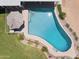 An eye-level view of the backyard pool including an umbrella and an area for residents to stand at 7042 N 13Th St, Phoenix, AZ 85020
