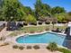 Inviting in-ground pool with a safety fence, lounging area, and serene backyard setting at 7042 N 13Th St, Phoenix, AZ 85020