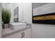 Modern powder bathroom with floating vanity, vessel sink, and contemporary art at 7347 E Vista Bonita Dr, Scottsdale, AZ 85255