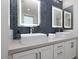 Elegant bathroom with dual sinks, lighted mirrors, and stylish blue tile at 7347 E Vista Bonita Dr, Scottsdale, AZ 85255