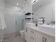 Modern bathroom featuring double sinks, a glass-enclosed shower, and sleek white tile at 7347 E Vista Bonita Dr, Scottsdale, AZ 85255