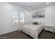 A bright bedroom includes a large window, modern art, and comfortable queen-sized bed at 7347 E Vista Bonita Dr, Scottsdale, AZ 85255