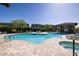 Resort-style community pool with lounge chairs, a hot tub, and lush landscaping at 7347 E Vista Bonita Dr, Scottsdale, AZ 85255