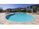 Resort-style community pool with lounge chairs, a hot tub, and lush landscaping at 7347 E Vista Bonita Dr, Scottsdale, AZ 85255