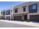 Contemporary townhome exterior with attached garage, stone accents, and well-maintained landscaping at 7347 E Vista Bonita Dr, Scottsdale, AZ 85255