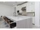 Contemporary kitchen with white cabinets, marble countertop island, and bar stool seating at 7347 E Vista Bonita Dr, Scottsdale, AZ 85255