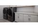 Well-equipped laundry room with stainless steel washer and dryer and ample counter space at 7347 E Vista Bonita Dr, Scottsdale, AZ 85255
