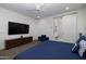Spacious bedroom with a sleek TV, modern decor, and ensuite bathroom at 7347 E Vista Bonita Dr, Scottsdale, AZ 85255