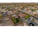 Expansive aerial view of the neighborhood, featuring the property with a well-manicured backyard and pool at 7425 W Caro Rd, Glendale, AZ 85308