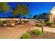 Outdoor brick patio with fireplace, seating, and a swimming pool in a well-maintained backyard at 7425 W Caro Rd, Glendale, AZ 85308