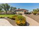 Backyard with a sidewalk, mature plants, lawn, and a small building at 7425 W Caro Rd, Glendale, AZ 85308
