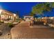 Landscaped backyard boasts an outdoor kitchen, fireplace and paved patio for entertaining at 7425 W Caro Rd, Glendale, AZ 85308