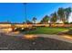 Expansive backyard with lush lawn, brick pathway, pool, and string lights creating ambiance at 7425 W Caro Rd, Glendale, AZ 85308