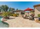 Backyard featuring a pool, mature trees, green grass and lounge chairs at 7425 W Caro Rd, Glendale, AZ 85308