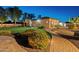 Manicured backyard with a well-maintained lawn, brick pathways, and mature landscaping at 7425 W Caro Rd, Glendale, AZ 85308