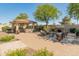 Landscaped backyard featuring a built-in grill, fireplace and paved patio for relaxing at 7425 W Caro Rd, Glendale, AZ 85308