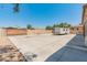 Large concrete backyard, enclosed by a block wall with a gate, ideal for recreational vehicles at 7425 W Caro Rd, Glendale, AZ 85308