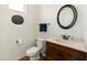 Well-lit bathroom with a round mirror, attractive vanity, and sleek fixtures at 7425 W Caro Rd, Glendale, AZ 85308