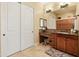This bathroom features ample cabinet space, a vanity with a stool, and a large mirror at 7425 W Caro Rd, Glendale, AZ 85308