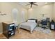 Well-lit bedroom with tile floors, shutters, a desk, and a full-sized bed at 7425 W Caro Rd, Glendale, AZ 85308