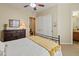 Comfortable bedroom with neutral colors, carpeted floor, and a decorative black iron bedframe at 7425 W Caro Rd, Glendale, AZ 85308