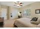 Comfortable bedroom with neutral colors and work space with shuttered window for natural light at 7425 W Caro Rd, Glendale, AZ 85308