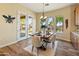 Bright dining area featuring french doors, wood floors, and views of the outdoor living space at 7425 W Caro Rd, Glendale, AZ 85308
