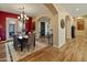 Dining room with hardwood floors, decorative lighting, and arched entryway at 7425 W Caro Rd, Glendale, AZ 85308
