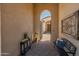 Inviting entryway with a stylish bench and potted plants at 7425 W Caro Rd, Glendale, AZ 85308