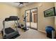 Bright exercise room with workout equipment, television, and sliding glass doors to outside patio area at 7425 W Caro Rd, Glendale, AZ 85308