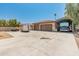 Spacious property with a three-car garage and an RV parking structure under clear blue skies at 7425 W Caro Rd, Glendale, AZ 85308