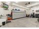 Well-organized garage with TV, wall cabinets, work sink, and storage for all your gear at 7425 W Caro Rd, Glendale, AZ 85308