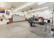 Well-lit garage with plenty of storage, a workbench, and an off-road vehicle inside at 7425 W Caro Rd, Glendale, AZ 85308