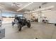 Open garage with a black off-road vehicle parked inside; well-lit and spacious at 7425 W Caro Rd, Glendale, AZ 85308