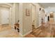 Hallway with archways, built-in bench, and tile and hardwood floors at 7425 W Caro Rd, Glendale, AZ 85308