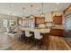 Spacious kitchen featuring wood cabinets, granite countertops, stainless steel appliances, and a breakfast bar at 7425 W Caro Rd, Glendale, AZ 85308