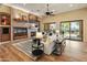 Open-concept living room with fireplace, tile accent wall and open-concept at 7425 W Caro Rd, Glendale, AZ 85308