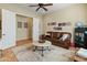 Cozy living room with leather sofa, accent rug, decorations, and an adjacent open office at 7425 W Caro Rd, Glendale, AZ 85308