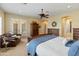 Bright, spacious bedroom with carpet, a ceiling fan, a leather chair and a closet at 7425 W Caro Rd, Glendale, AZ 85308
